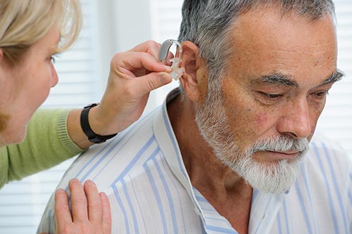old man hearing aid